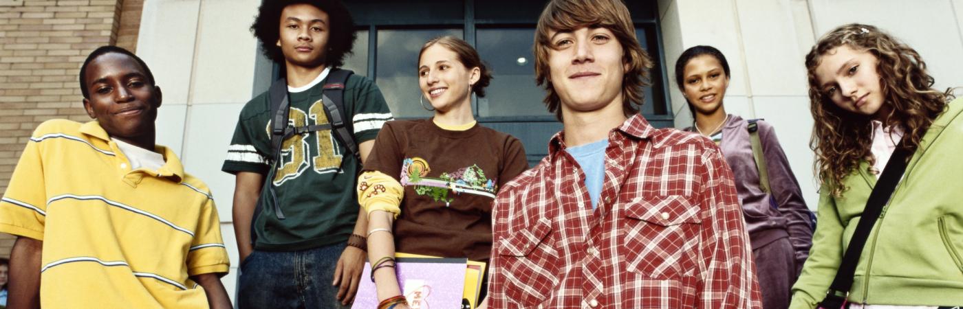 teens standing in front of school