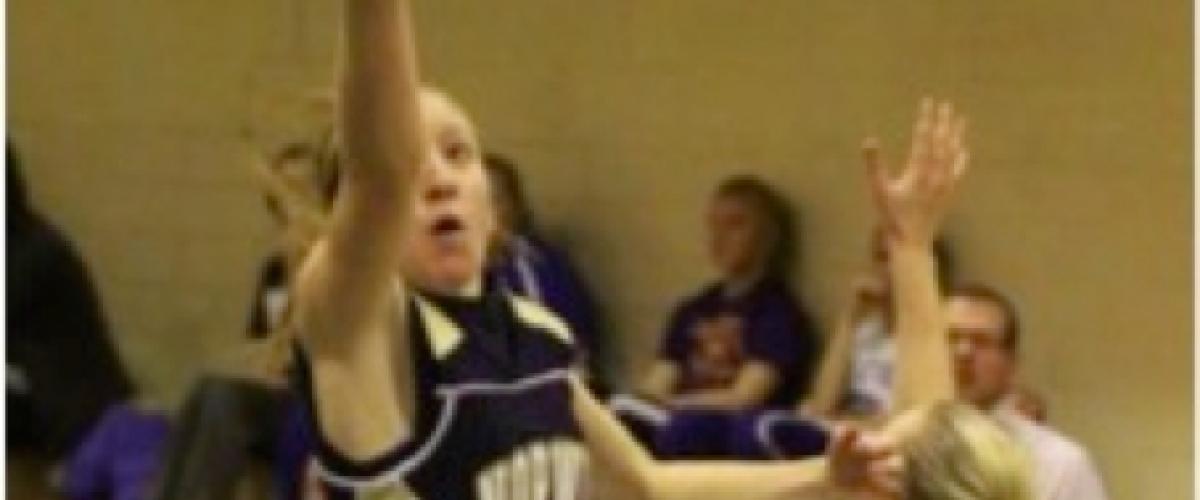 Author Abbey Zorzi playing basketball as a high school junior