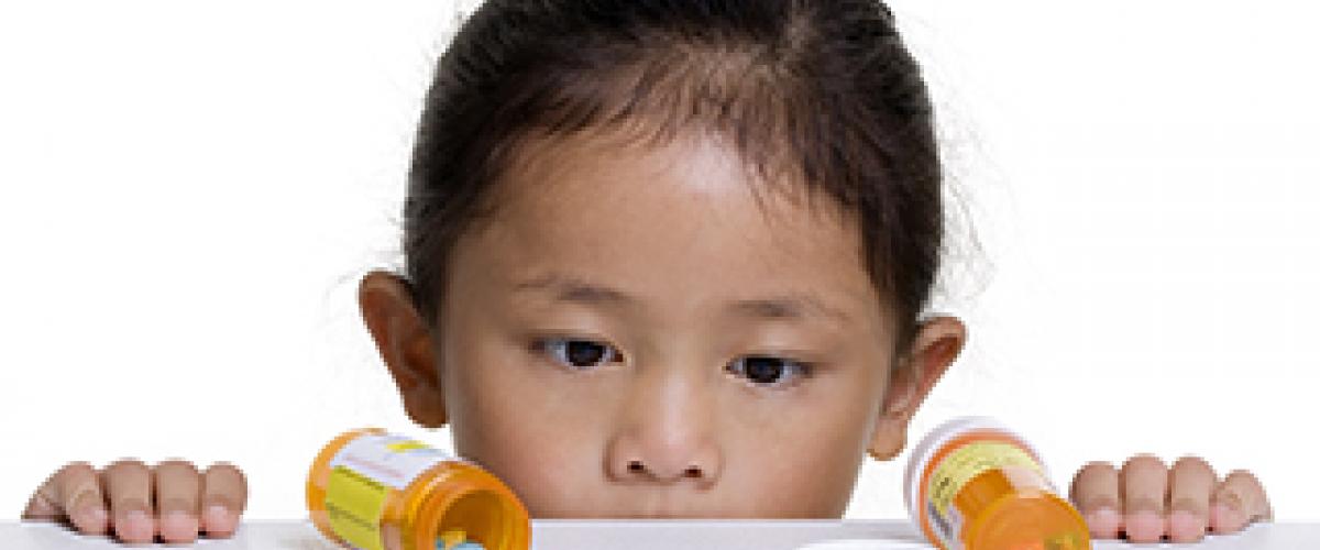 Child with Prescription Medicine bottles