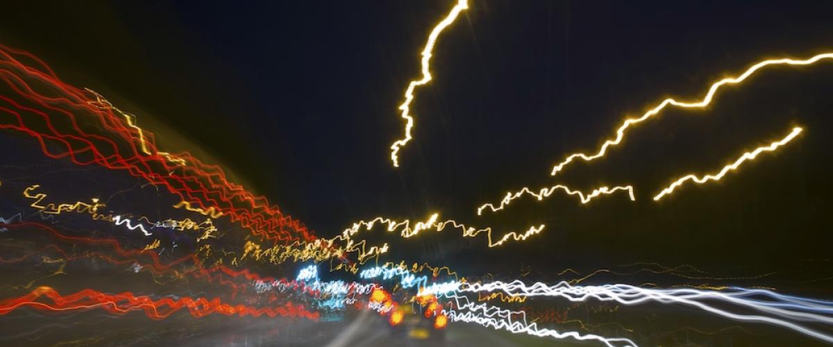 Blurred nighttime road from perspective of a drugged driver