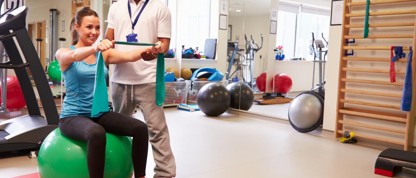 physical therapist working with female patient