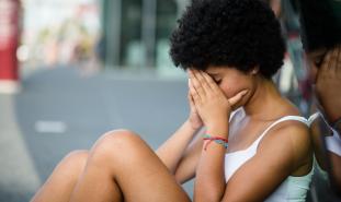 sad teen girl sitting on the ground