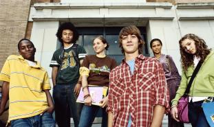 teens standing in front of school