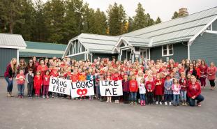 Students hold signs reading "Drug Free Looks Like Me"