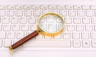 Magnifying glass on laptop