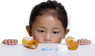 Child with Prescription Medicine bottles