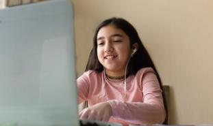 girl sitting behind laptop