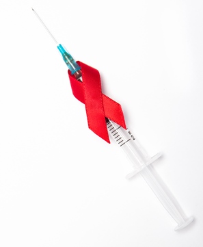 syringe wrapped with red ribbon