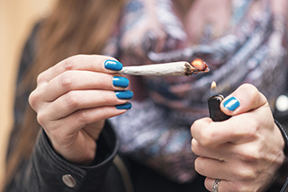 Young person with marijuana joint